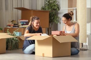 Roommates unpacking boxes in their new ohio university rental